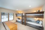 The bunk room offers 4 twin beds, queen sleeper sofa & living room.